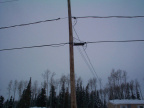 The cables for the internect access is wrapped around the telephone wires.