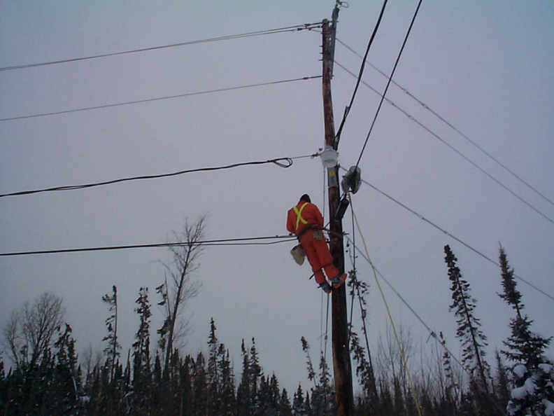 next will be to attach the cable line that is on the ground and wrap it around the telephone wire.