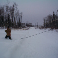 Here's one of the guys pulling on the rope which lifts the cable line up and attached to the telephone line.