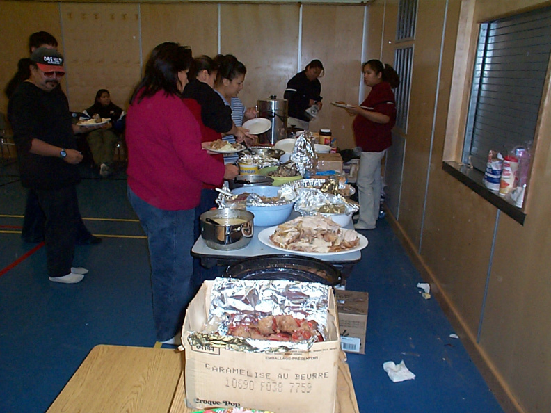 More food. Volunteers are serving plates to the community.