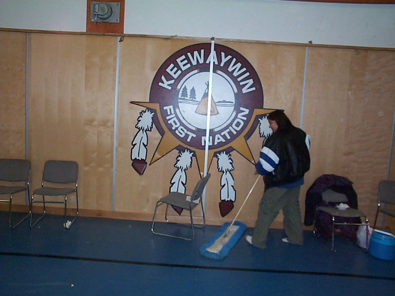 Thats Allison Kakepetum sweeping up the floor by the Keewaywin Logo.