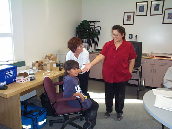 Brenda Pascal, Keewaywin's teacher assistant is there to help with the nurse give flu shots for her students.