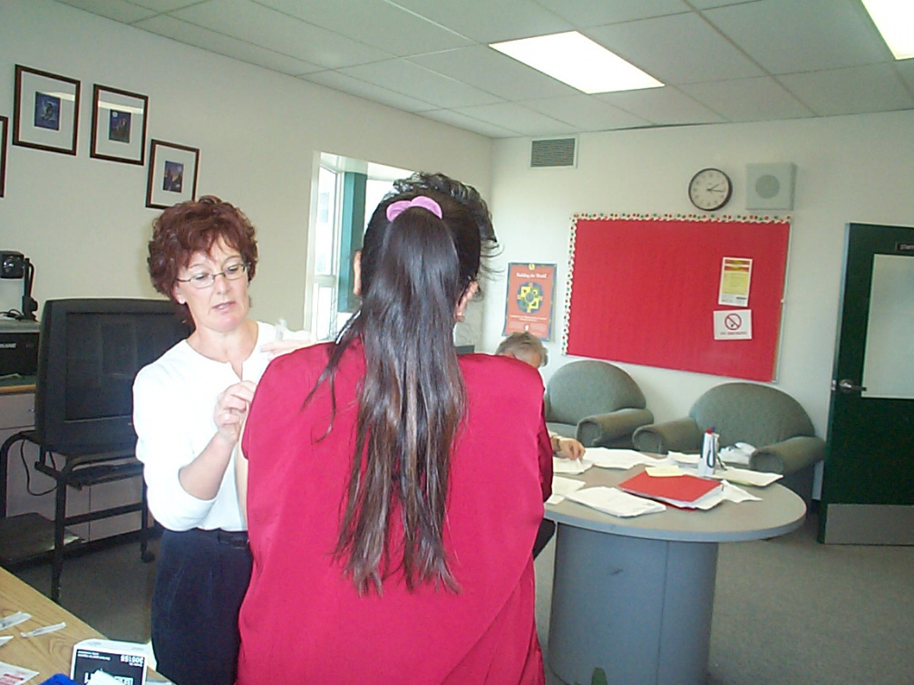 Brenda Pascal, another teachers assistant gets her flu shot.