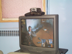 Phillip Bottle and Bill Fox of Bearskin Lake First Nation work together with K-Net staff to get their video conferencing unit se