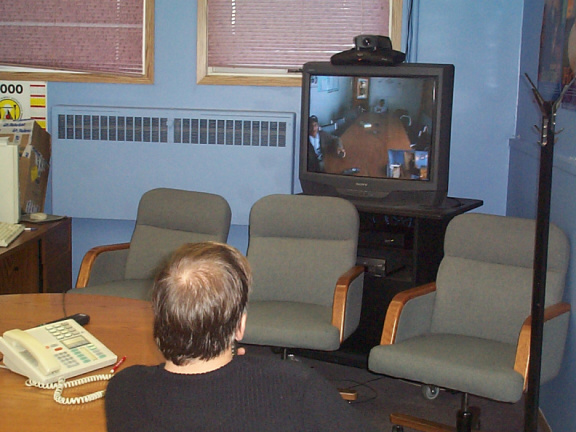 Bearskin Lake staff working with K-Net staff to test out their new video conferencing tools