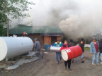 Community members moving the gas drums, and propane tanks.