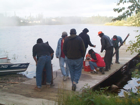 Getting the water pump going, after Susan Rae brought gas from her truck.