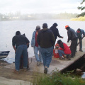 Getting the water pump going, after Susan Rae brought gas from her truck.