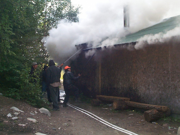 Spraying the building with the fire hose.