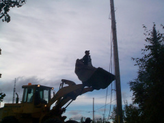 Martin Kakegamic going to the pole, to cut the wires from hydro poles to the building.