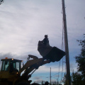 Martin Kakegamic going to the pole, to cut the wires from hydro poles to the building.