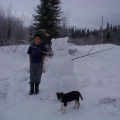 Tyler Meekis and his pupppy "Lady" posing for a picture with his snow scuplur.