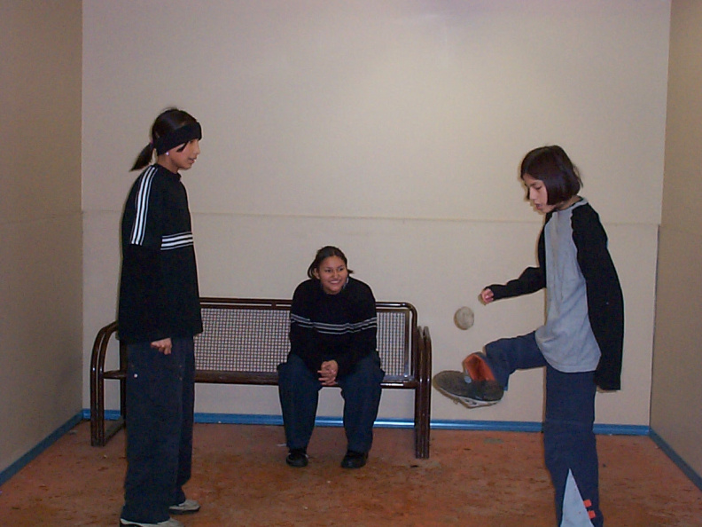 A couple girls playing hackie while they wait for Wasaya Airways.