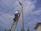 Mr Dale Jack climbing the pole, checking all connections.