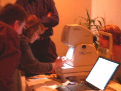 Health professionals view teleopthalmology equipment in operation.
