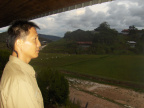 Ayoe Overlooking the Fields from a Longhouse