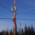 Climbing the pole to put the wiring cable in place.