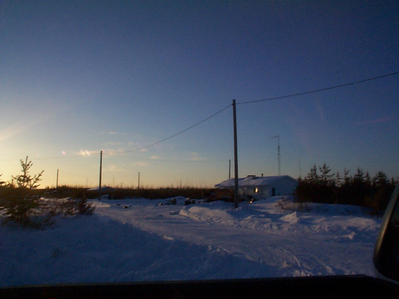 A view of Darby's house with the sunsetting.