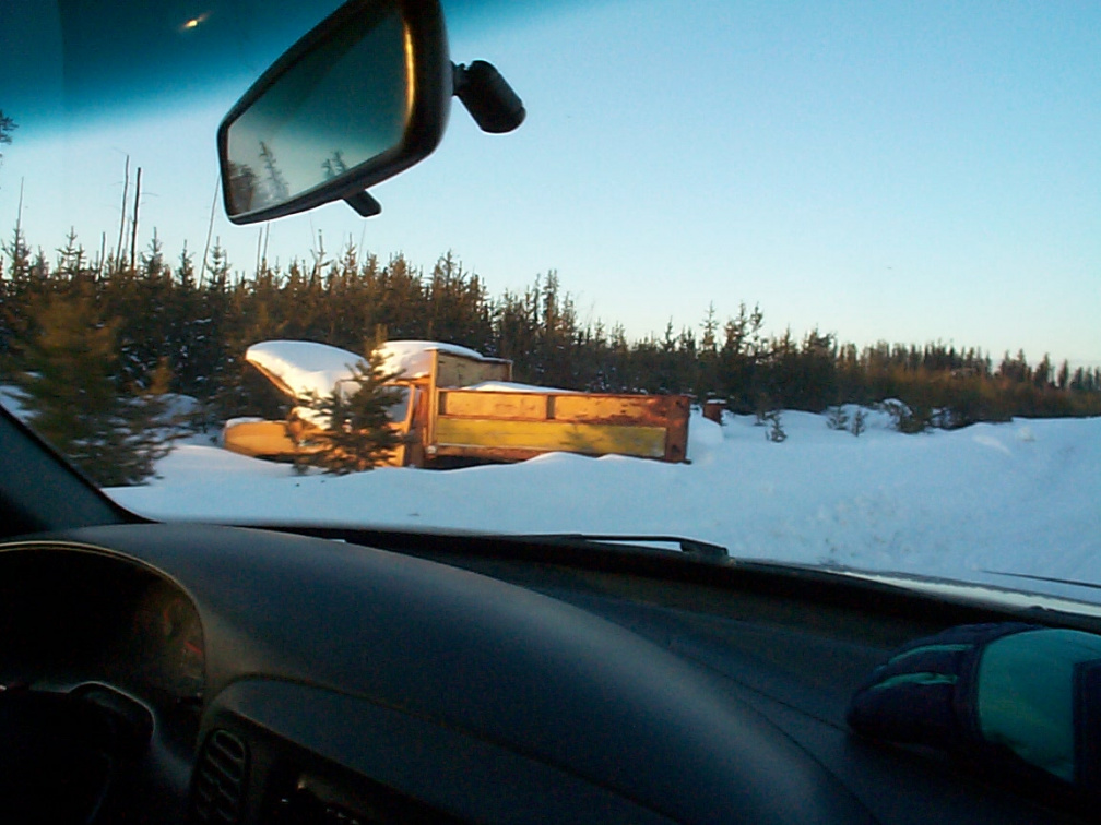 one of the broken vehicles abandoned along the road.