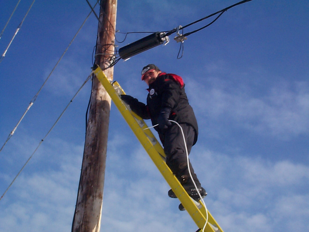 Raymond hooking up a line from the pole which will be hooked up to the house.
