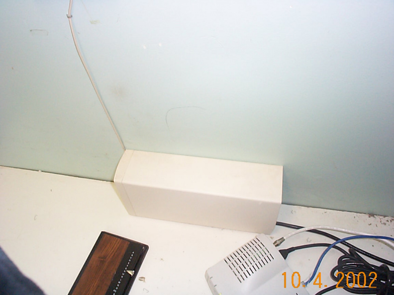 something on the shelf of howard's office with aside modem and also blue cables.