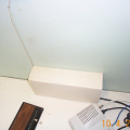 something on the shelf of howard's office with aside modem and also blue cables.