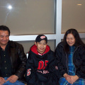 Reynold with his mom and dad at the airport in Thunder Bay on his way home