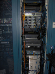 Old routers and switches rear view.