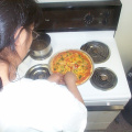 Crysal Rae prepares the pizza.