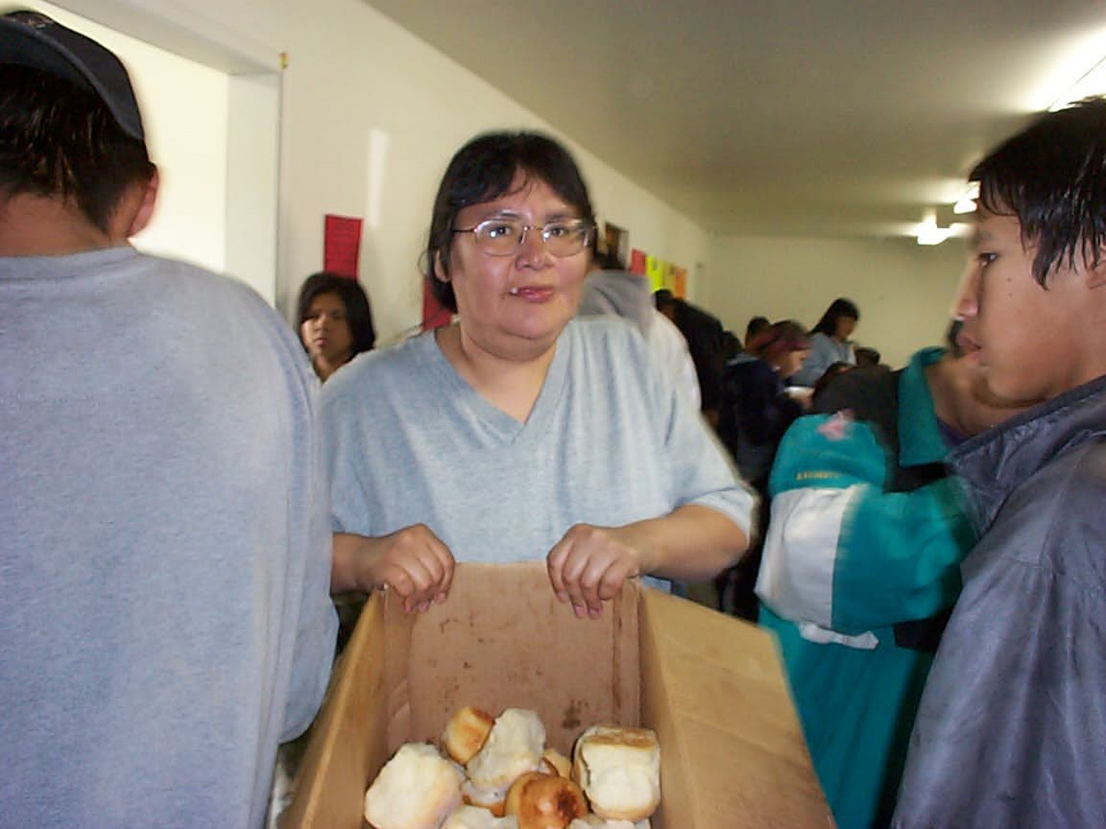 Delilah Rae passing out bannock to the people