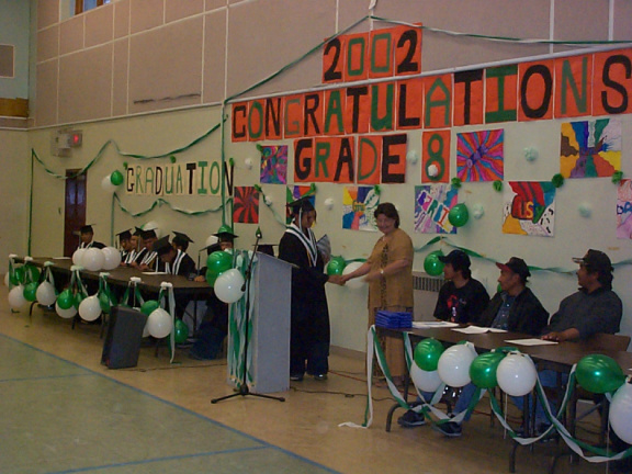One of the graduates recieving their diploma.