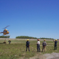 They learned about hooking up the cargo net.Another guy signalling the heicopter.