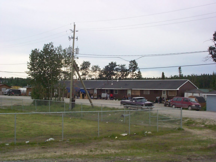 That long building is the teacherage,alot of people sitting in the shade.