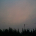 A picture of the sun with the smoke in the air.