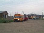 The school bus sits close by the airport, with the medical van right behind it.