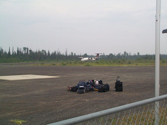 Here is the plane on the runway, with the luggage on that will be ready to be loaded.