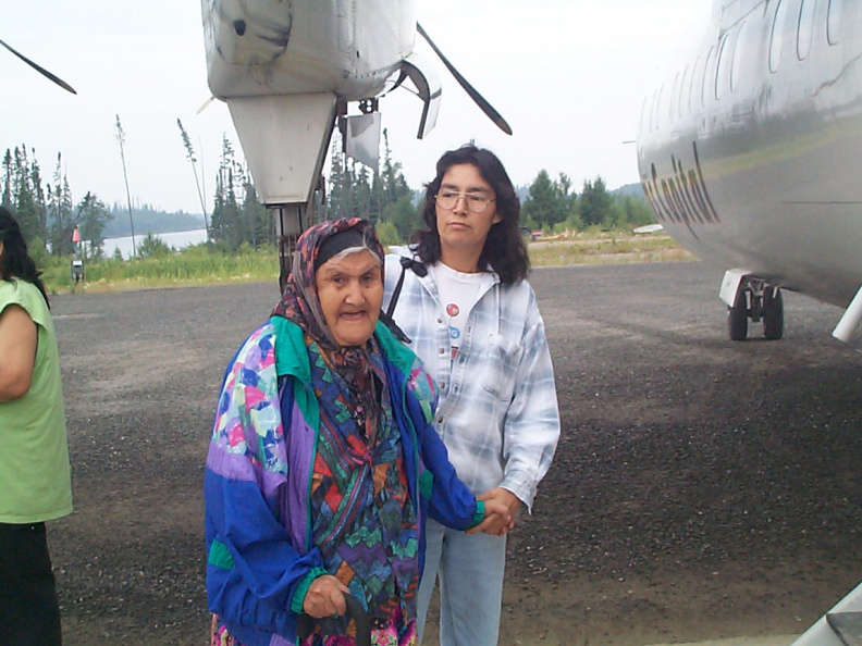 Edler, Julia Mawakeesic, receives support to help her on board, from her grand daughter, Deborah Rae.