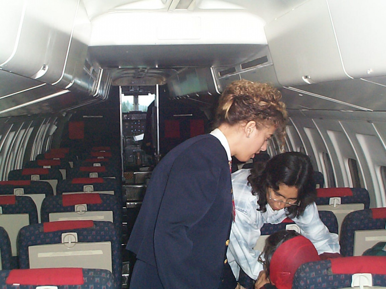 Here Deboarh Rae, helps Nancy Linklater, with the stewardess standing by to assist if necessary.