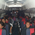 A picture taken from the front of the plane as they were all seated.