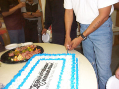 Oscar does the honors of cutting the cake
