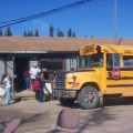 Students of David Meekis Memorial School arrive by the school bus