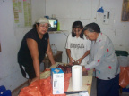 Elodie (right) shows Carol and Beverly how to clean the ducks