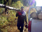 well here's Andy carrying a log on one shoulder and carrying the chainsaw
