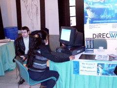 a delegate checking out her email at one of the few internet access computers set up at the booths