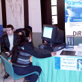 a delegate checking out her email at one of the few internet access computers set up at the booths