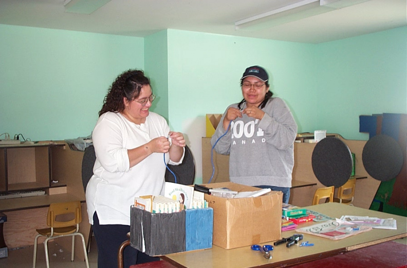 One of the RMO administrators showing the grade 4 - 8 teacher, Paula Armstrong how to make her own network cable.