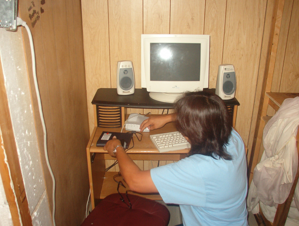 Darlene making the connection with the cable modem to ensure that it was compatible for the homes in North Spirit Lake.