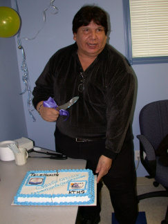 Tom Bressette cuts the cake.