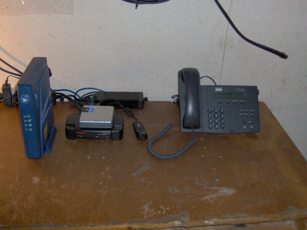 Ka satellite modem (left) wireless router equipment and Cisco IP telephone