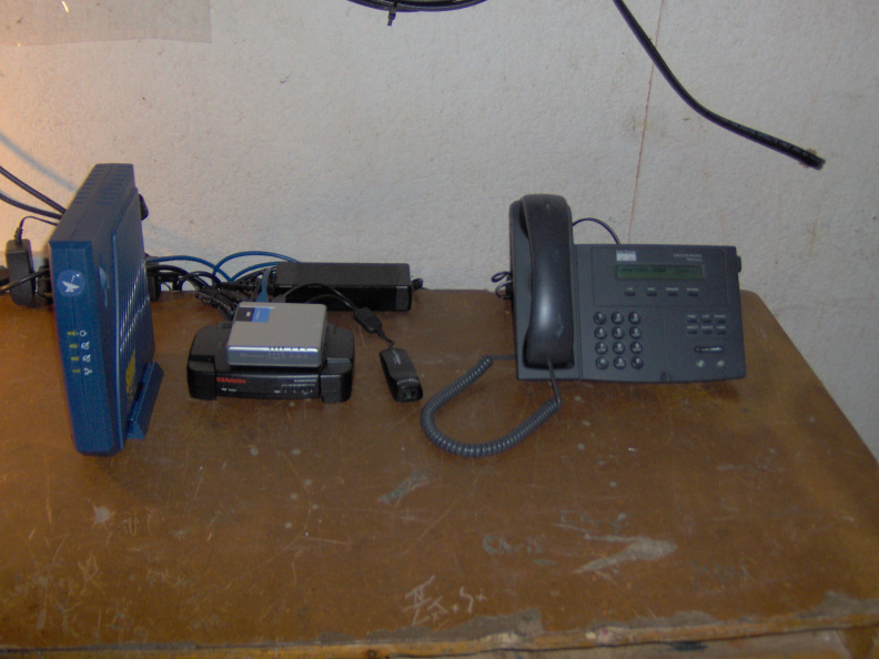 Ka satellite modem (left) wireless router equipment and Cisco IP telephone